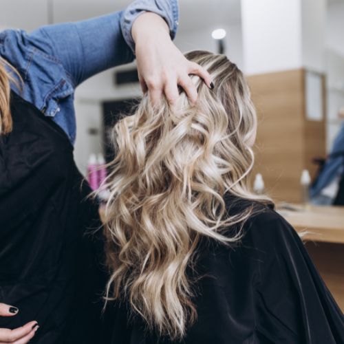 A woman getting her hair done in a salon