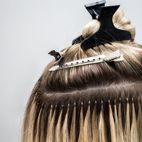 A close up of a woman's hair with scissors on it