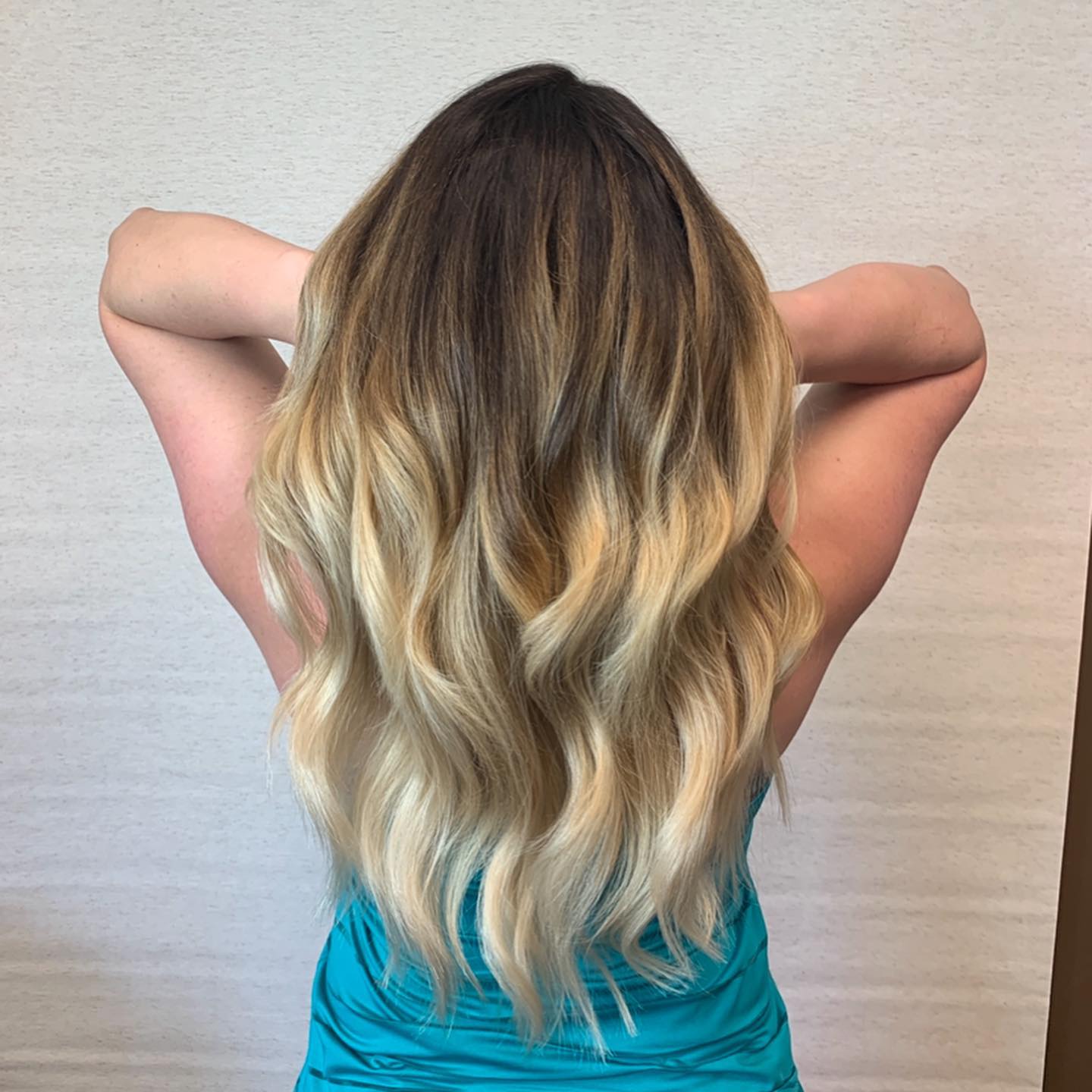 The back of a woman's head with long blonde hair